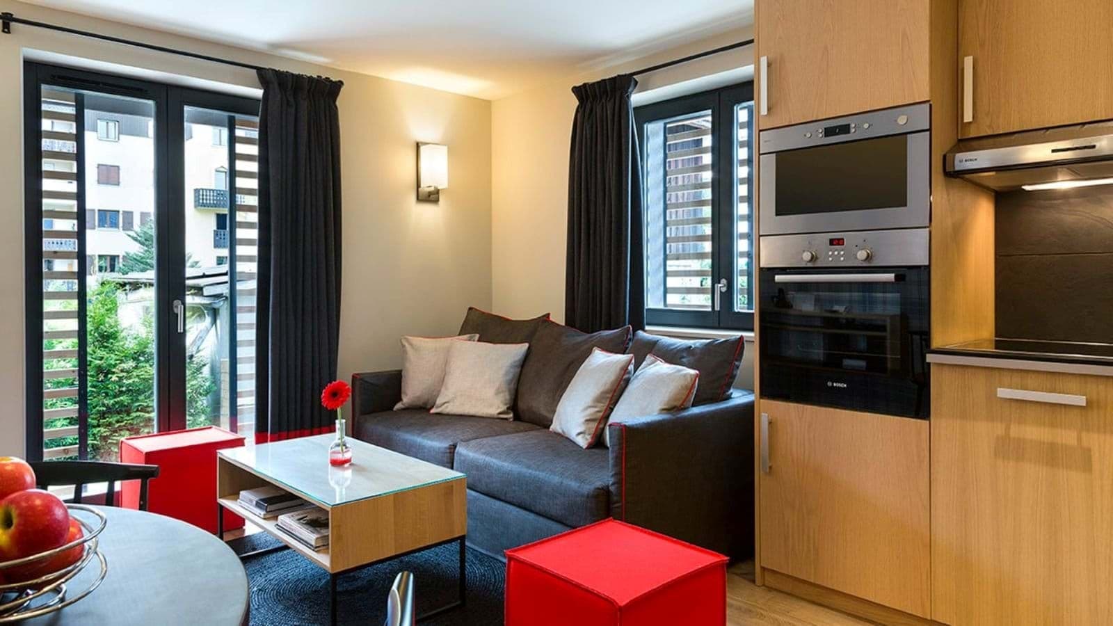 Compact living area with sofa bed and Bosch wall oven