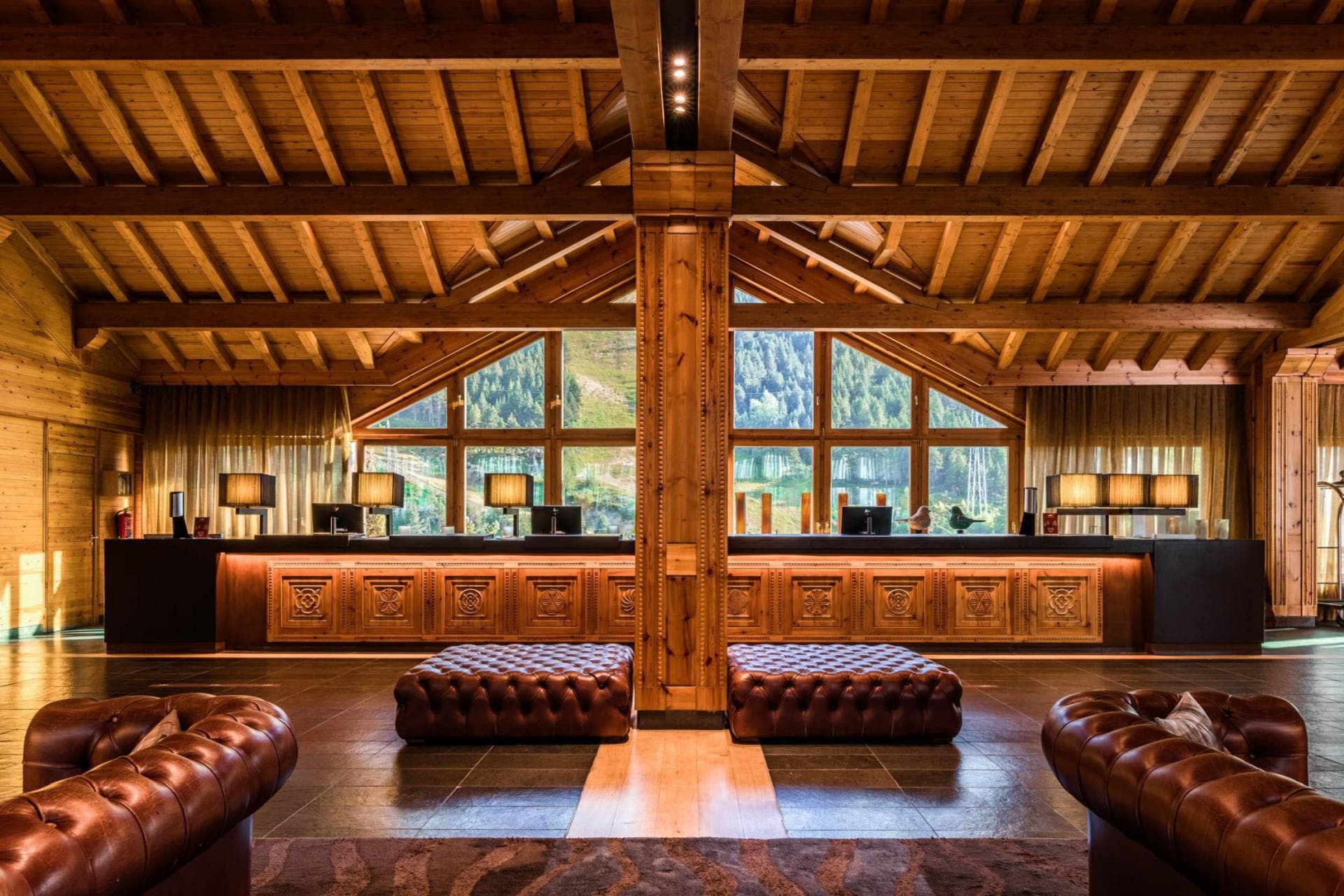 Lobby area with exposed timber ceiling and mountain forest views