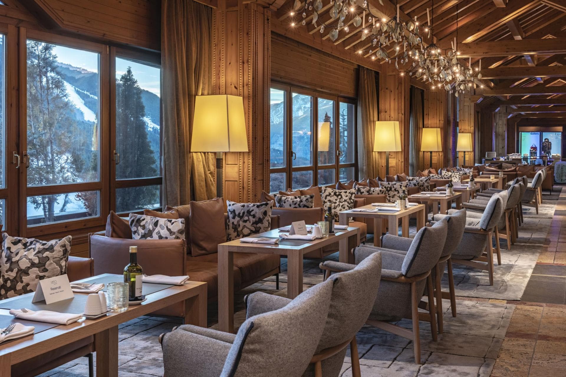 Dining area with floor-to-ceiling windows and ski slope views