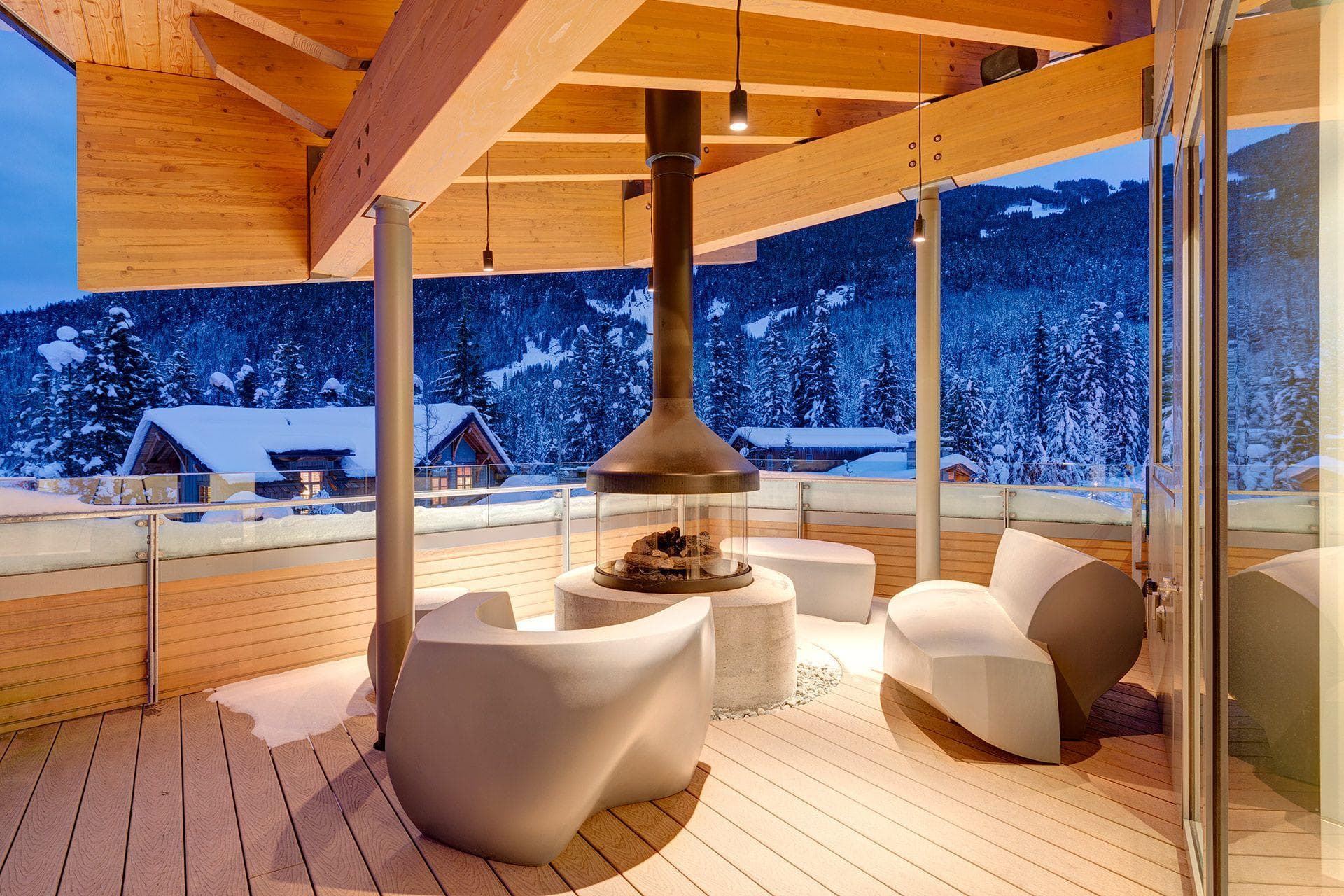 Covered deck with circular gas fire pit and mountain views