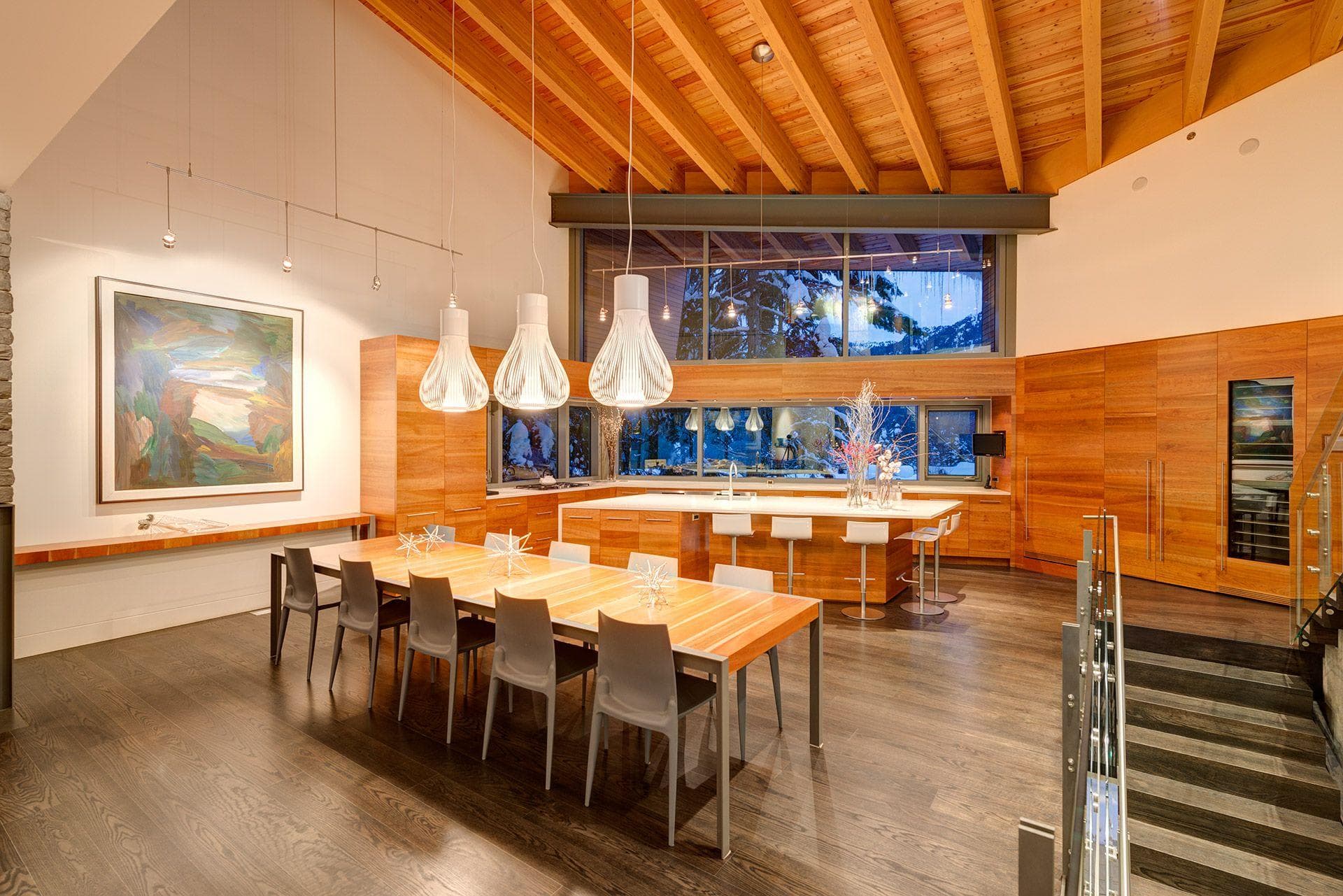 Open-plan dining area and kitchen with island seating and built-in wine fridge