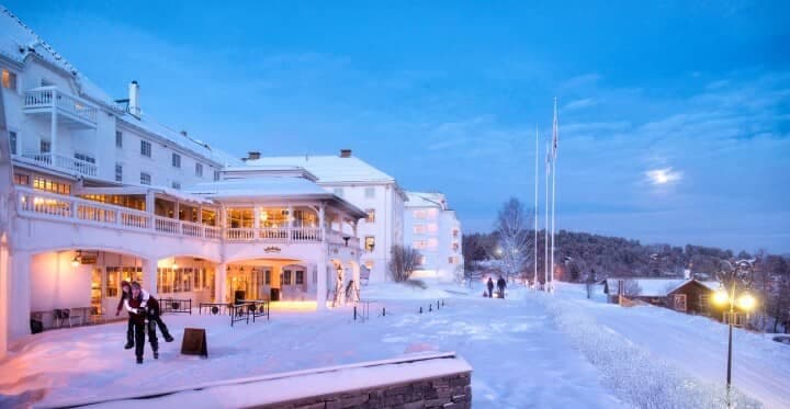 Lodge exterior with on-site ice skating rink and private balconies