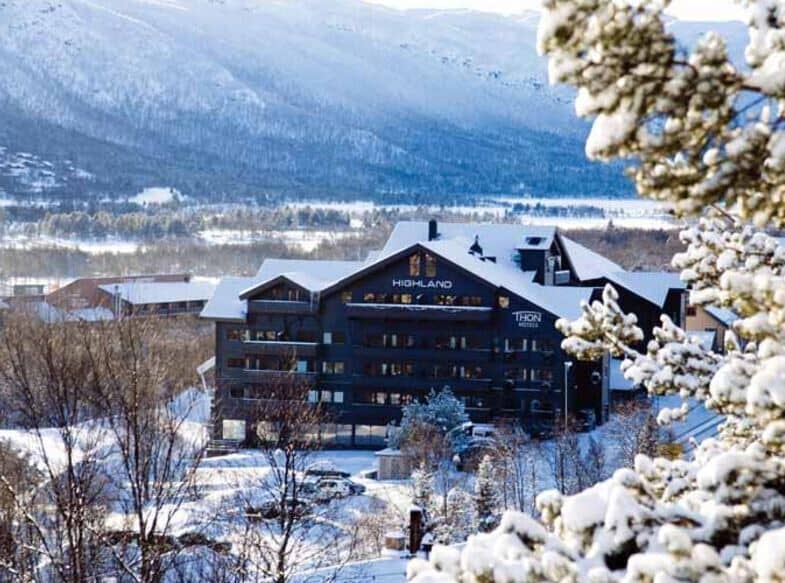 Lodge exterior with private balconies and snow-covered mountain views