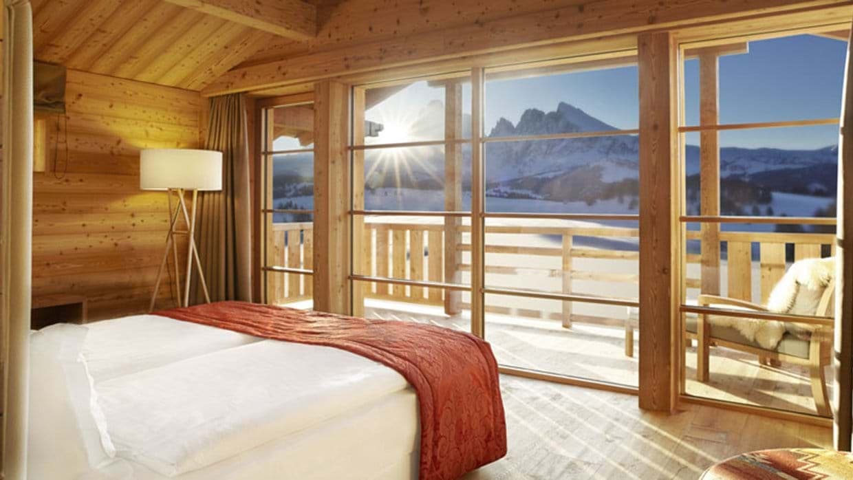 Primary bedroom with private balcony and Dolomite mountain views