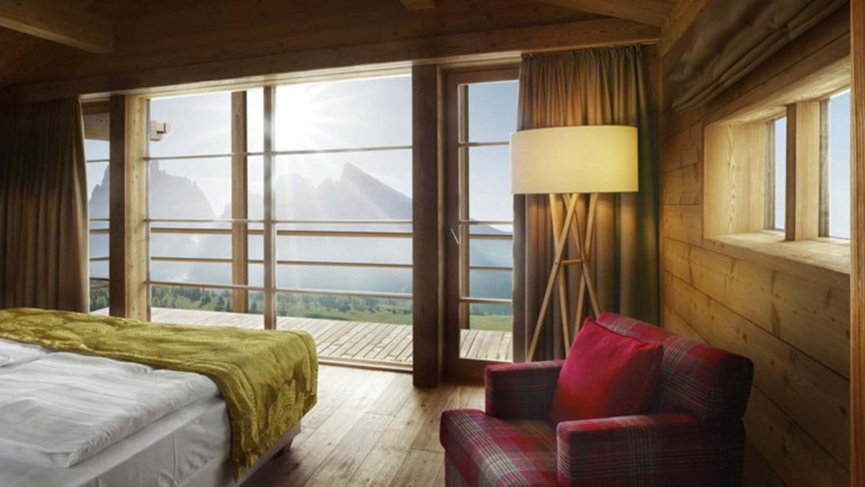 Log cabin bedroom with terrace access and mountain views