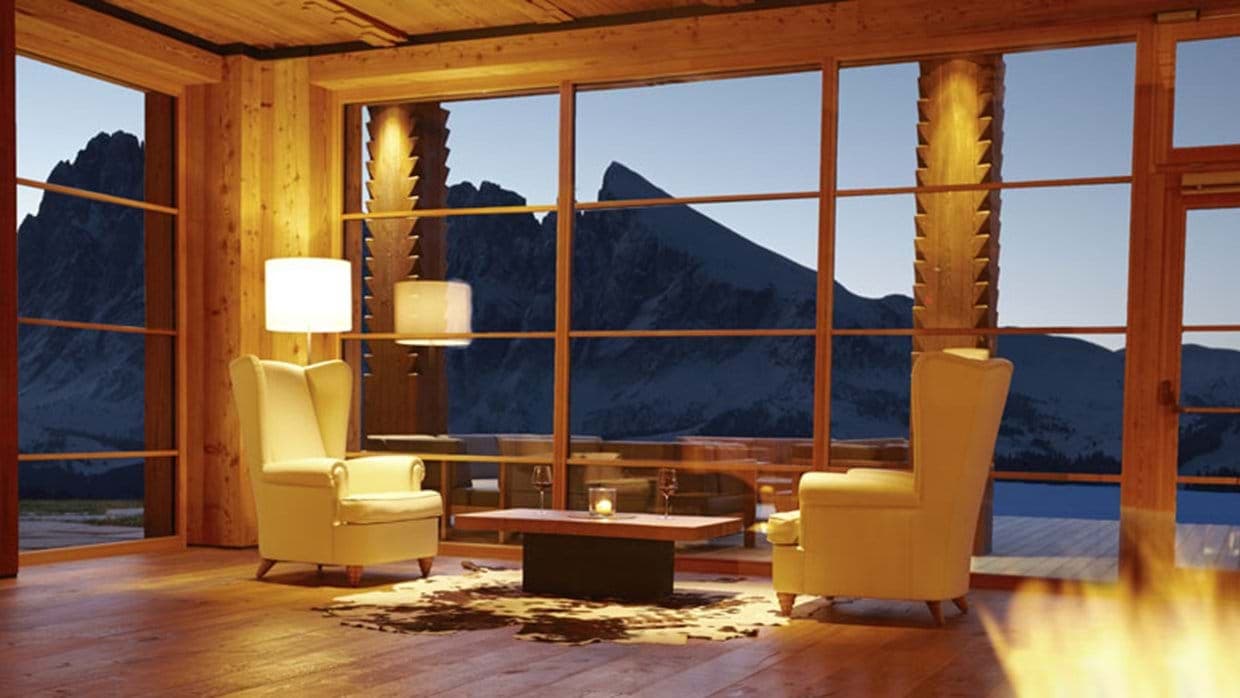 Lounge area with wingback chairs and panoramic Dolomite mountain views