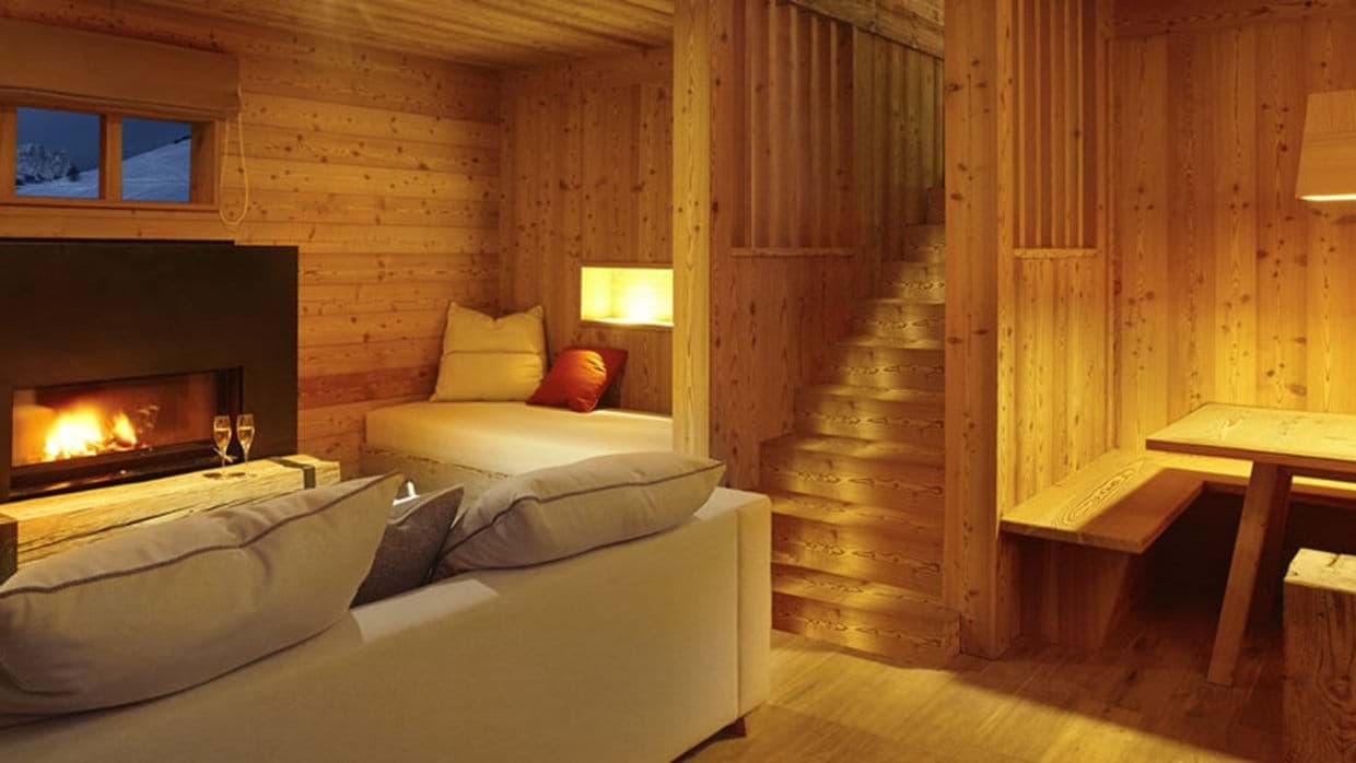 Living area with wood-burning fireplace, reading nook, and breakfast booth seating