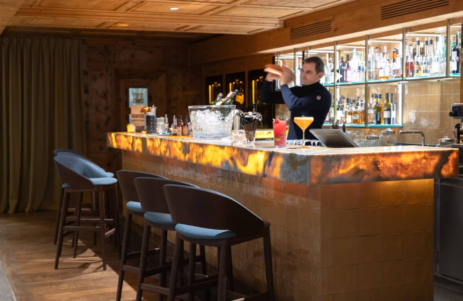 Private bar with backlit onyx counter and seating for 5