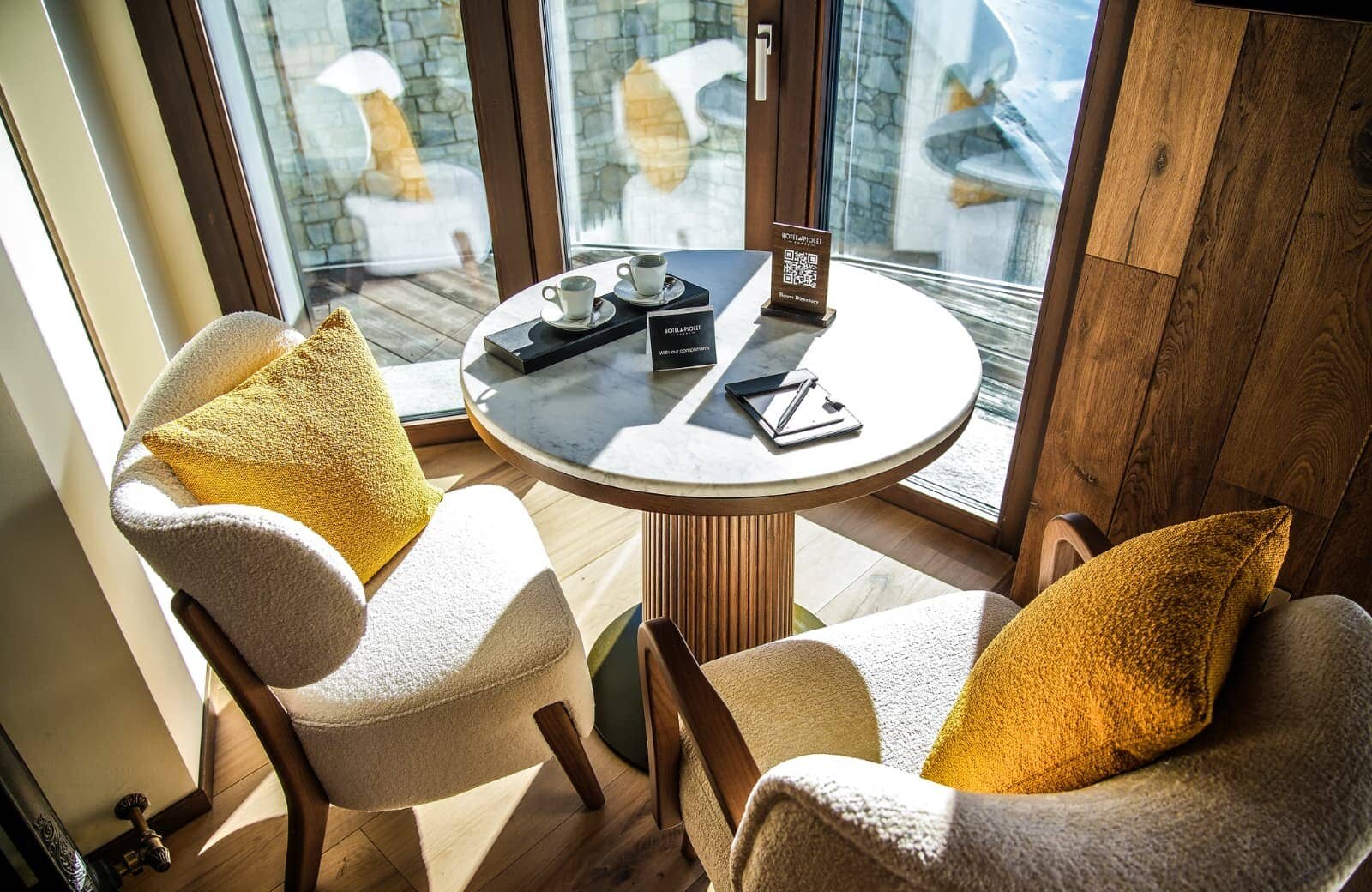 Marble breakfast table for two with floor-to-ceiling windows and balcony access