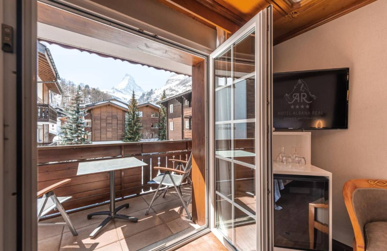 Private balcony with table, seating, and direct view of the Matterhorn