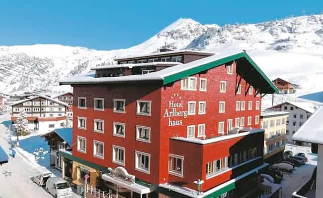 Ski-in, ski-out hotel exterior with mountain views and on-site parking