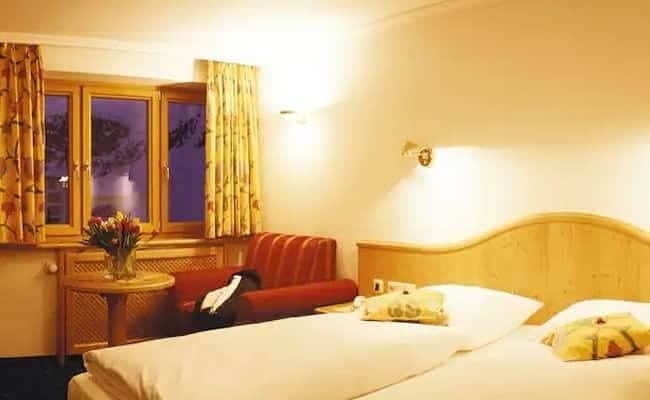 Guest bedroom with twin beds and armchair seating nook