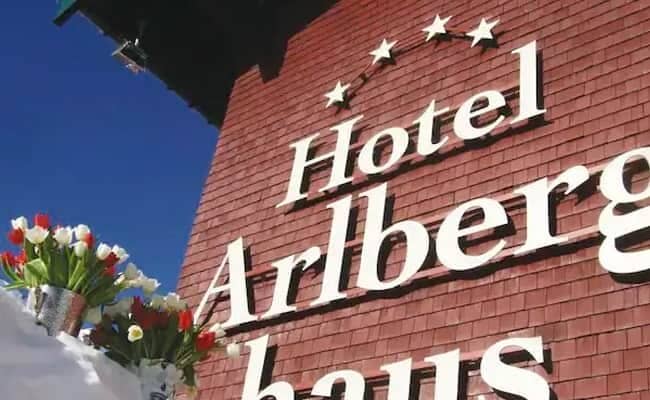 Hotel exterior featuring red cedar shingle siding and five-star rating