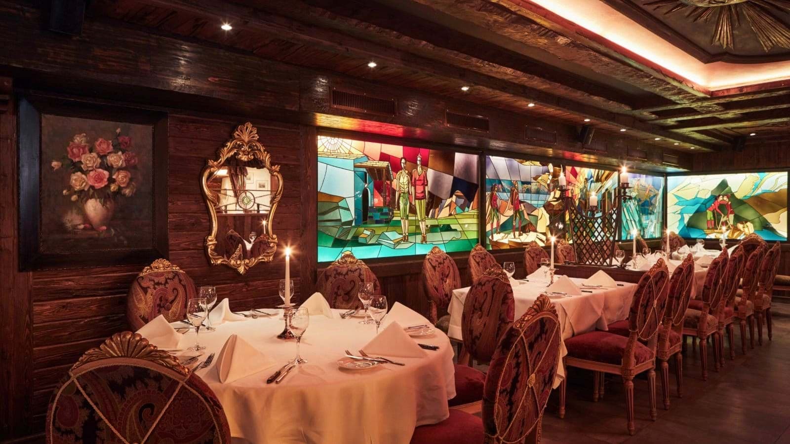 Formal dining room with stained-glass murals and seating for 20 guests