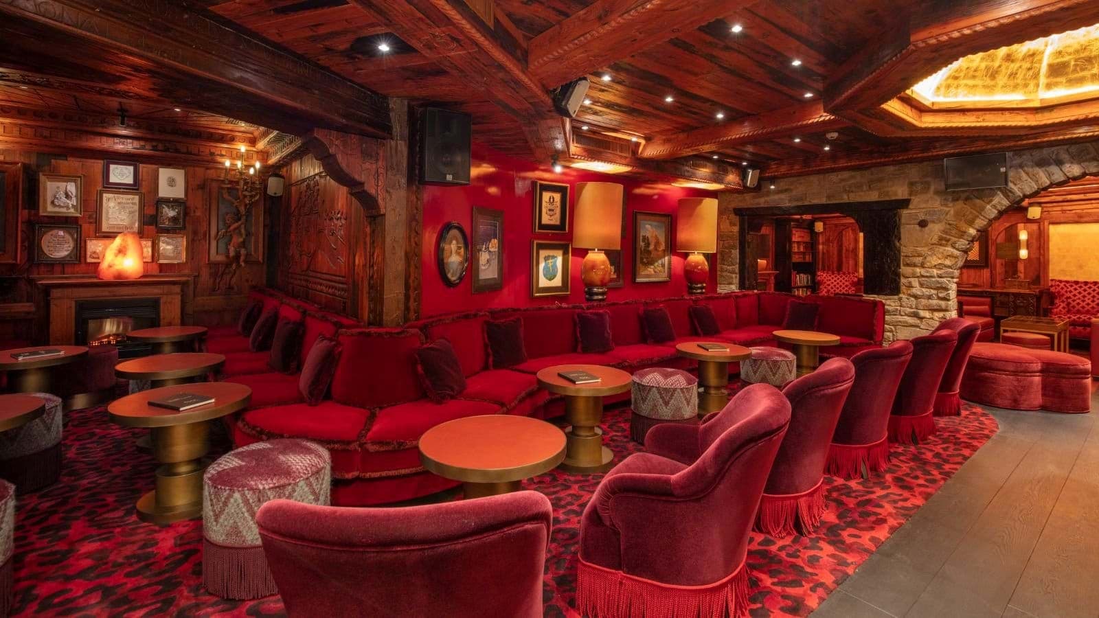 Private lounge with velvet banquette seating and electric fireplace