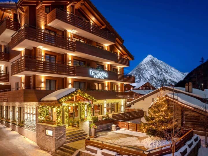 Chalet exterior with private balconies and mountain peak views