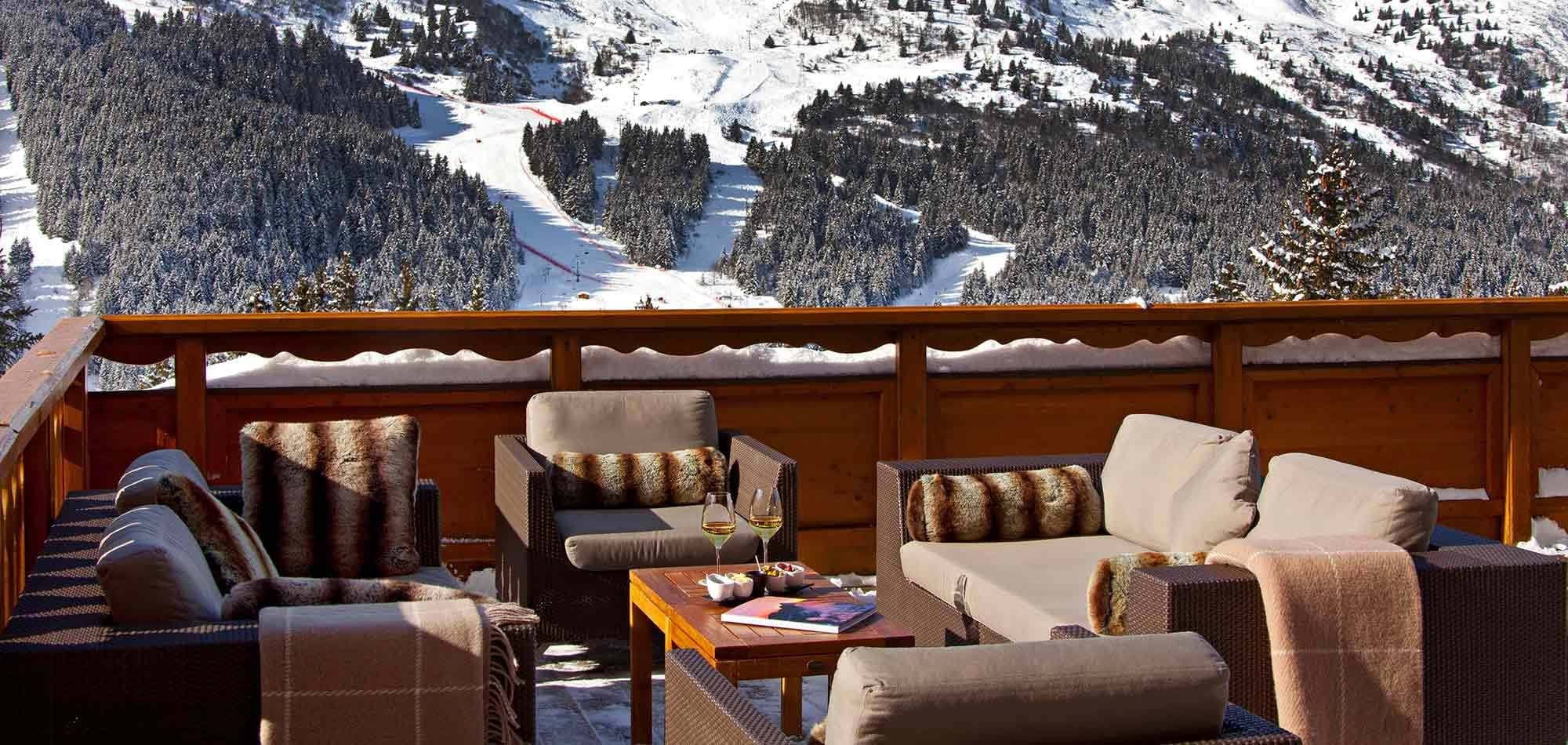 Private terrace with lounge seating and views of the ski runs