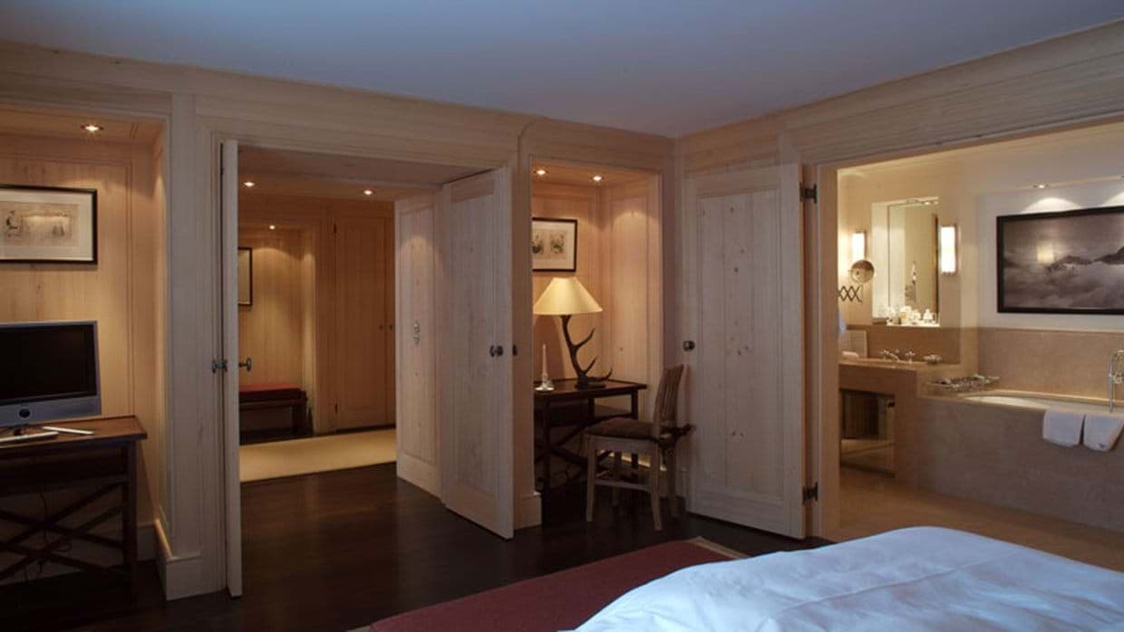 Primary bedroom with king bed and ensuite bathroom with soaking tub