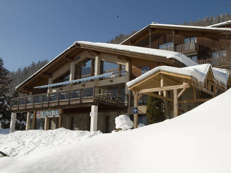 Chalet exterior featuring wrap-around sun deck and on-site Alpen Roc restaurant