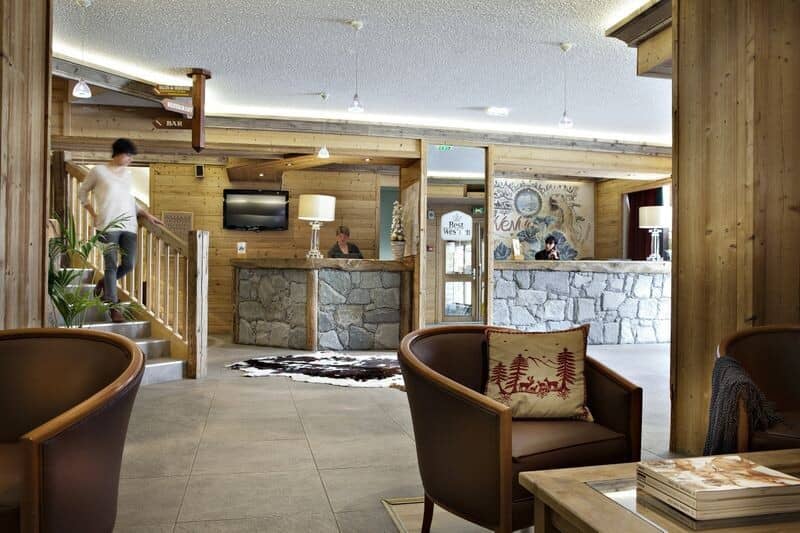 Lobby area with stone reception desks and lounge seating