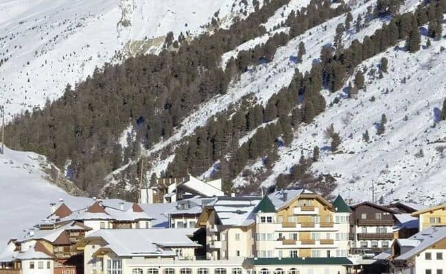 Ski village exterior with proximity to forested mountain slopes