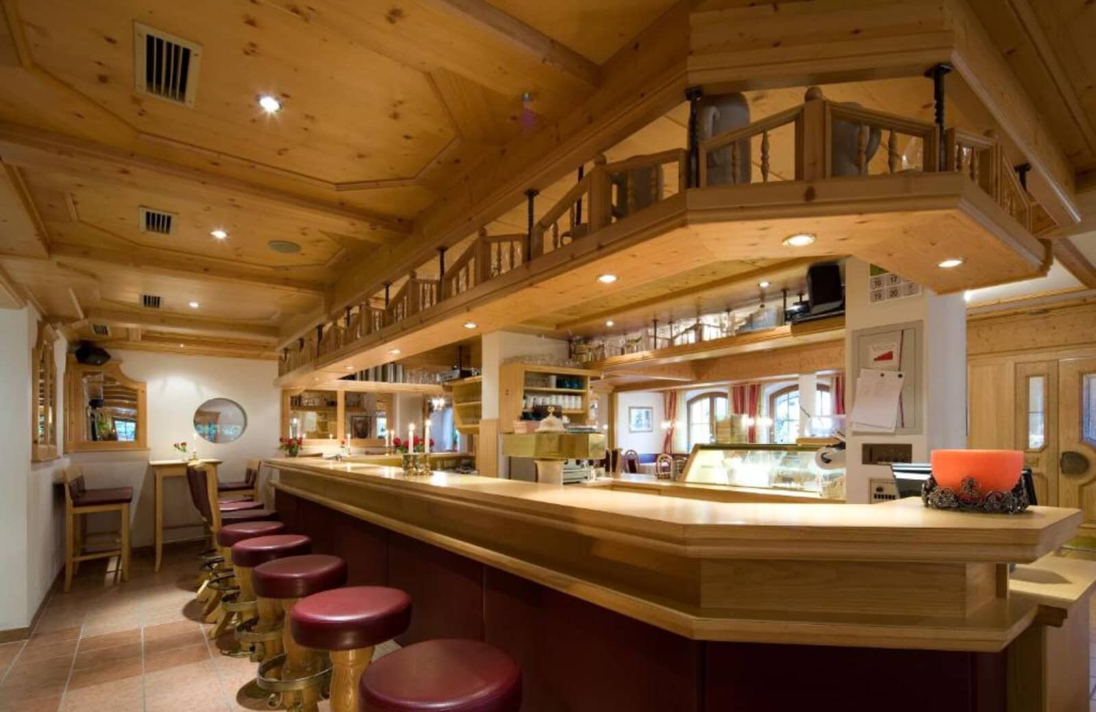 Wood-paneled bar area with draft beer tap and seating for 7