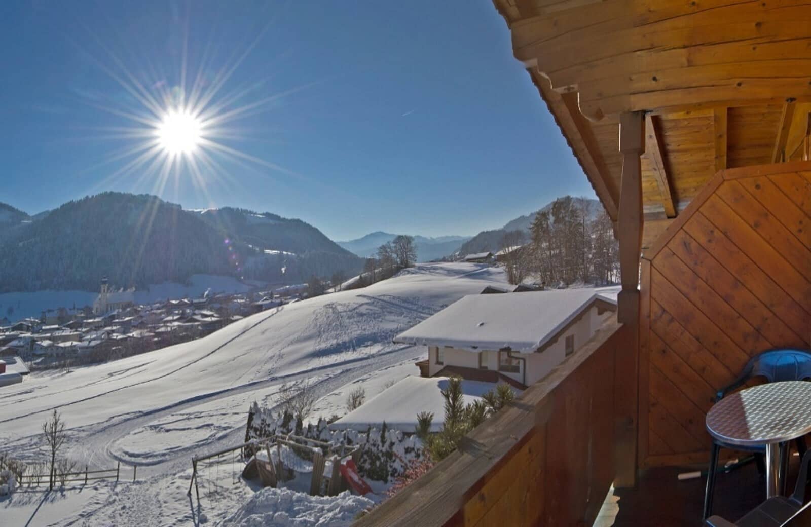 Private wooden balcony with mountain views and bistro seating