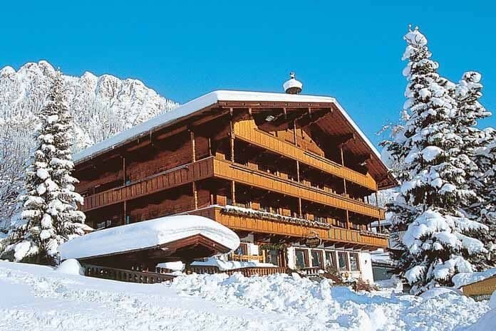 Chalet exterior with multiple private balconies and mountain views