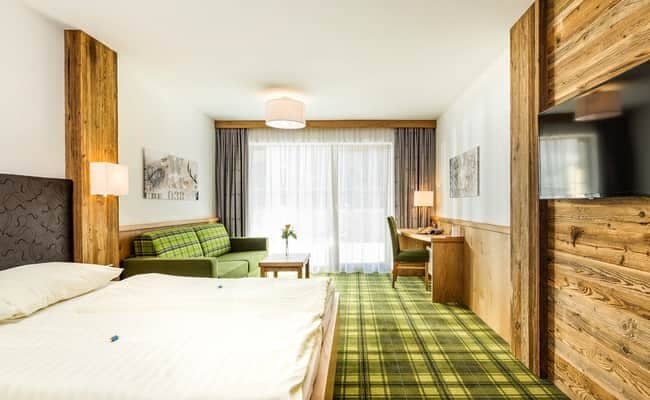 Guest suite with king bed, sofa, and dedicated workspace