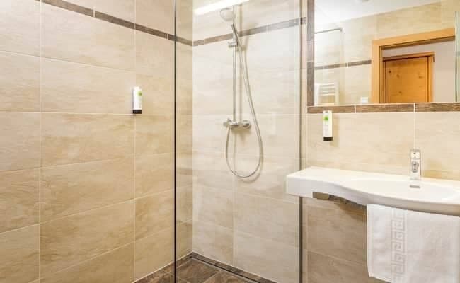Bathroom with walk-in rainfall shower and heated towel rack