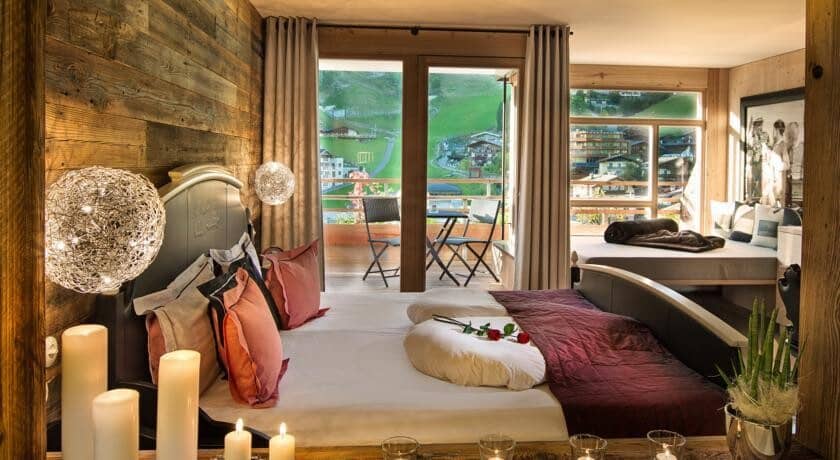 Primary bedroom with private balcony access and village views