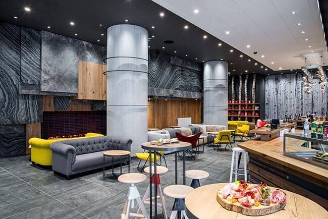 Shared lounge and cafe with fireplace and bistro-style seating