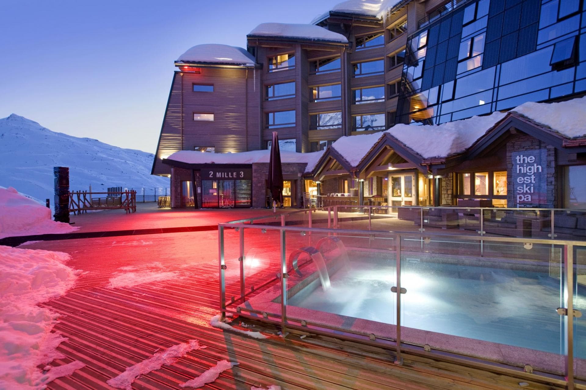 Ski-in/ski-out terrace featuring heated pool and mountain views