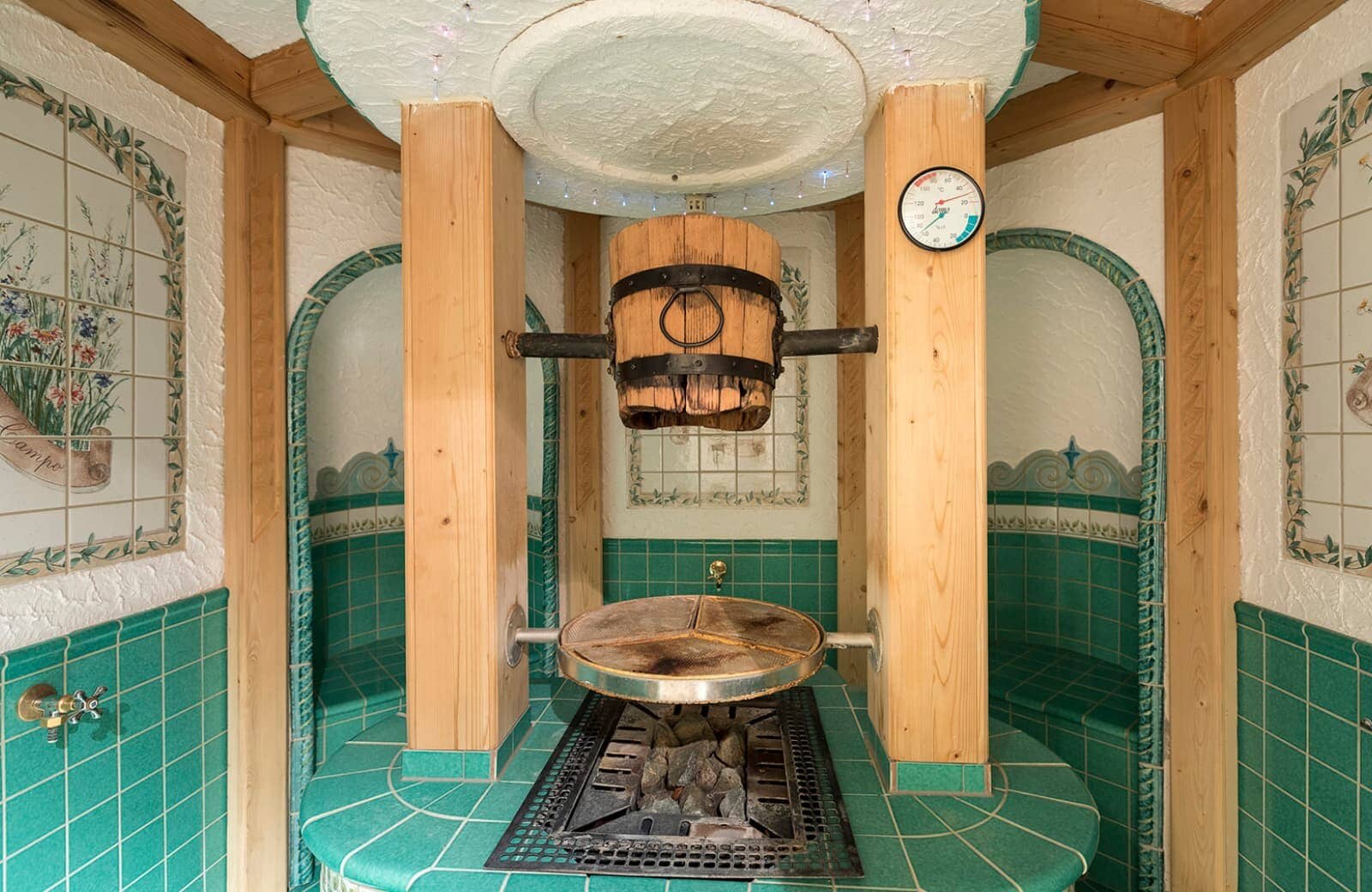 Traditional sauna with overhead dousing bucket and heated stone hearth
