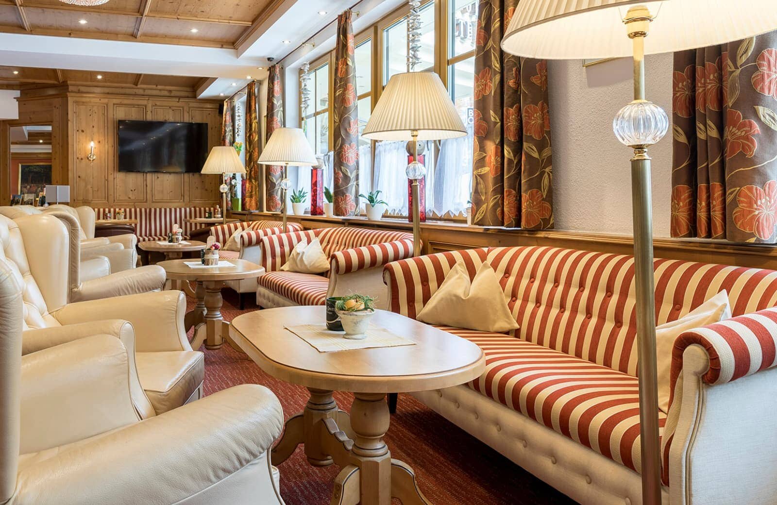 Shared lounge featuring wood-paneled walls and wall-mounted TV