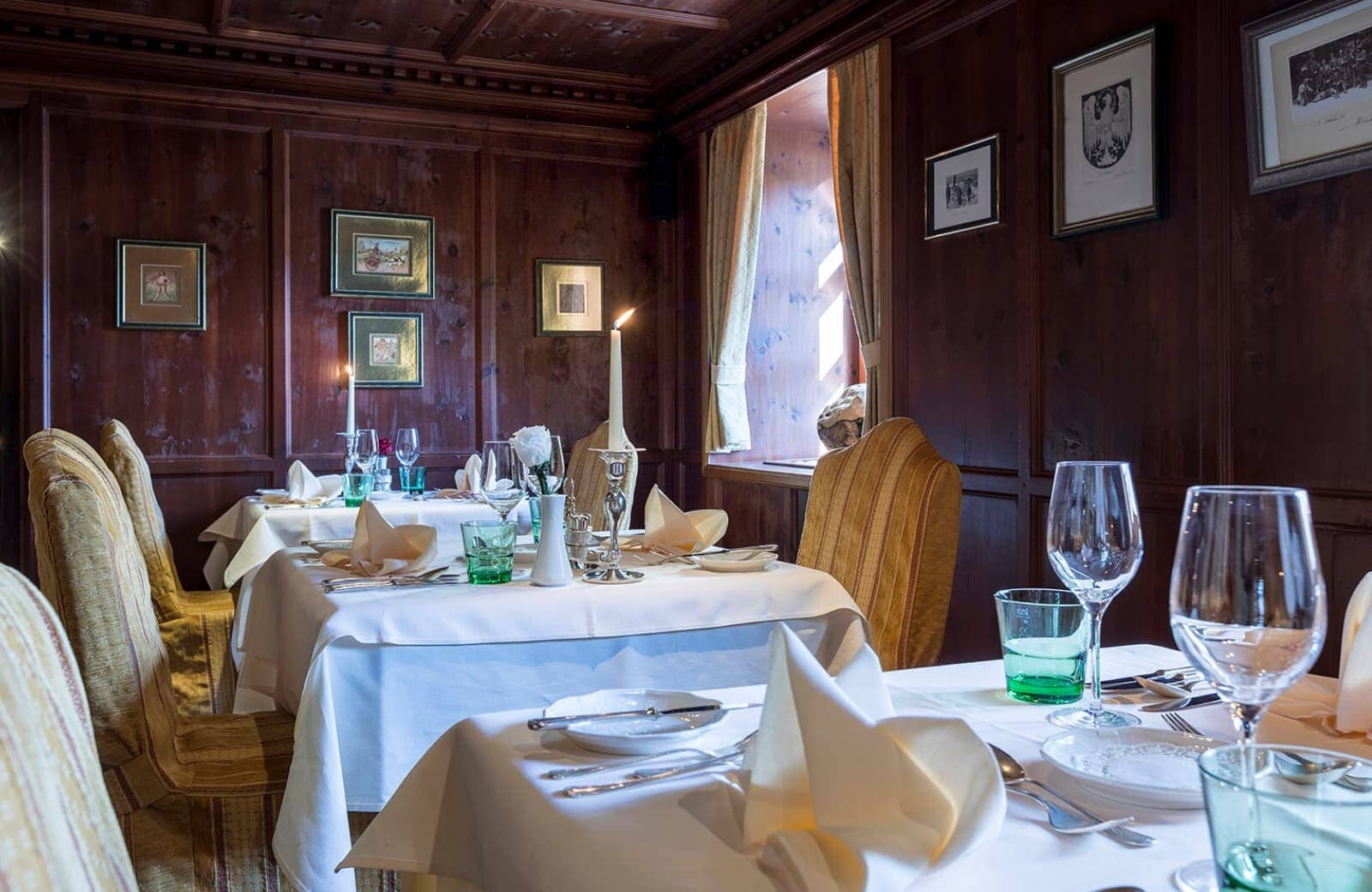 Dining room with traditional wood paneling and formal multi-table seating