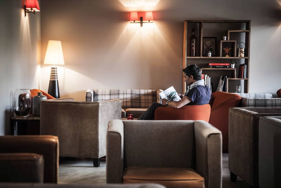 Lounge area with armchair seating and curated library shelving