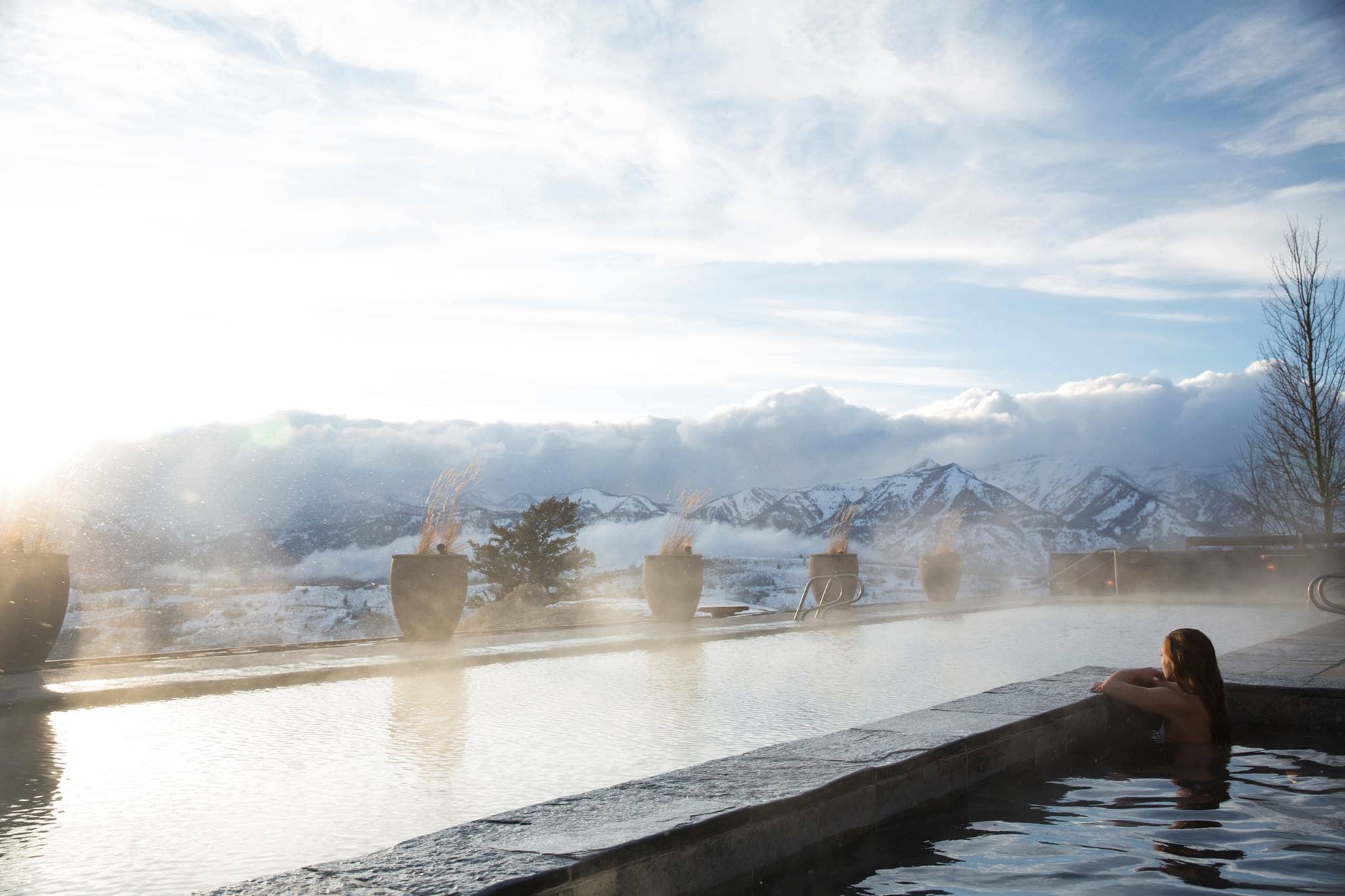Heated infinity pool and hot tub with mountain range views