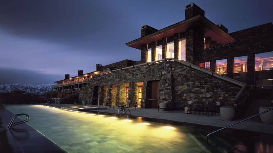 Heated infinity pool and spa with mountain views at dusk