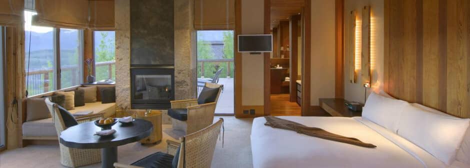 Primary suite with king bed, gas fireplace, and private deck access