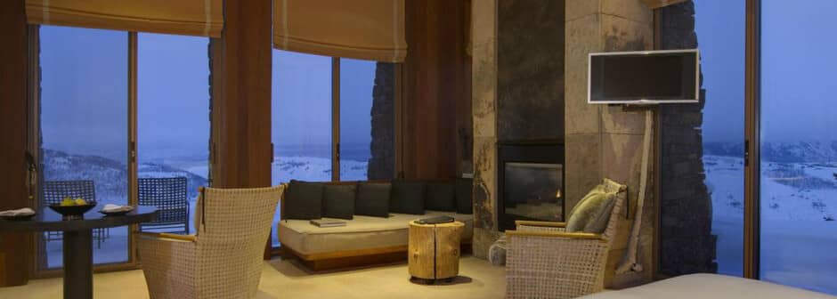 Living area with gas fireplace and floor-to-ceiling mountain views