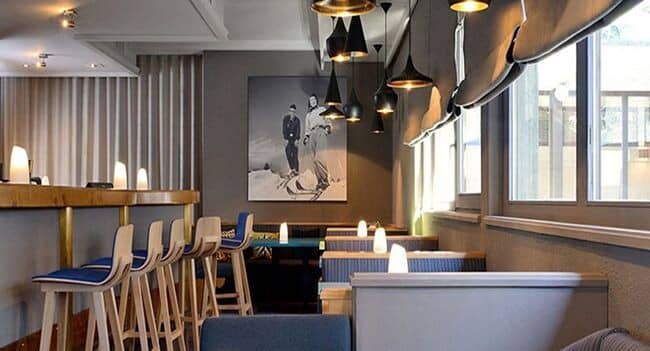 Lounge area with breakfast bar seating and semi-private booth tables