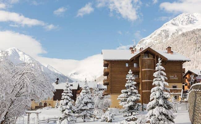 Wood-clad chalet featuring private balconies and alpine mountain views