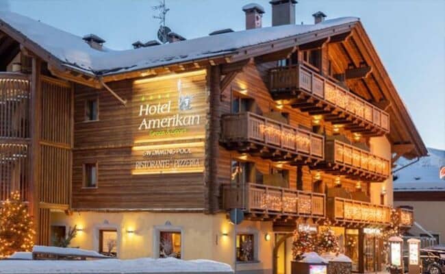 Chalet-style exterior with private balconies and on-site restaurant and pool