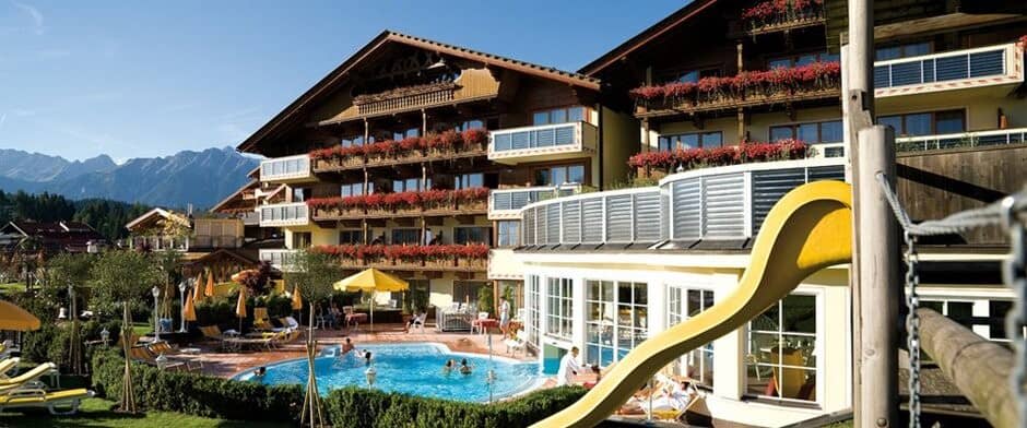 Outdoor heated pool and terrace with mountain views and children's slide