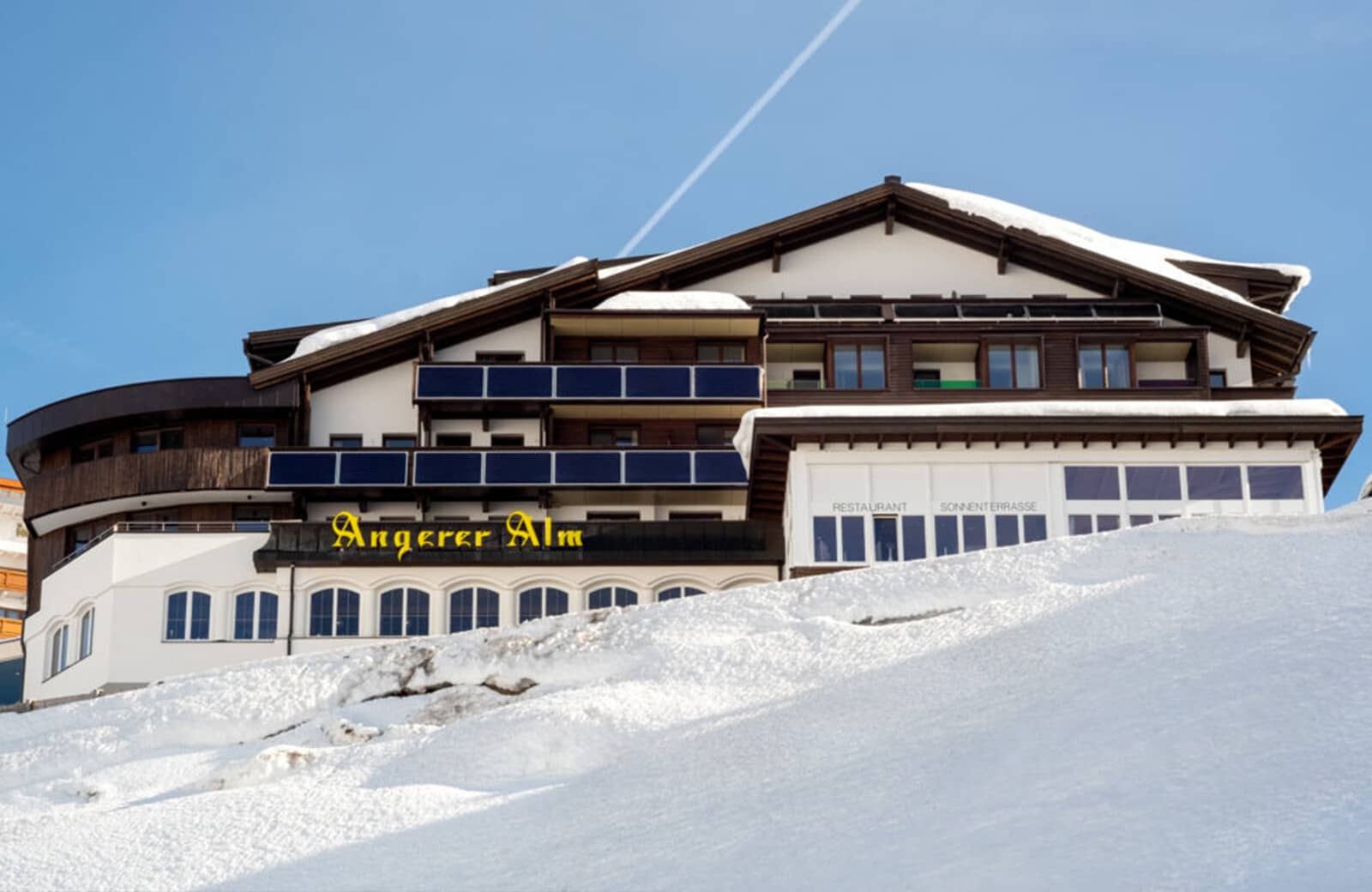 Ski-in/ski-out chalet exterior featuring on-site restaurant and sun terrace