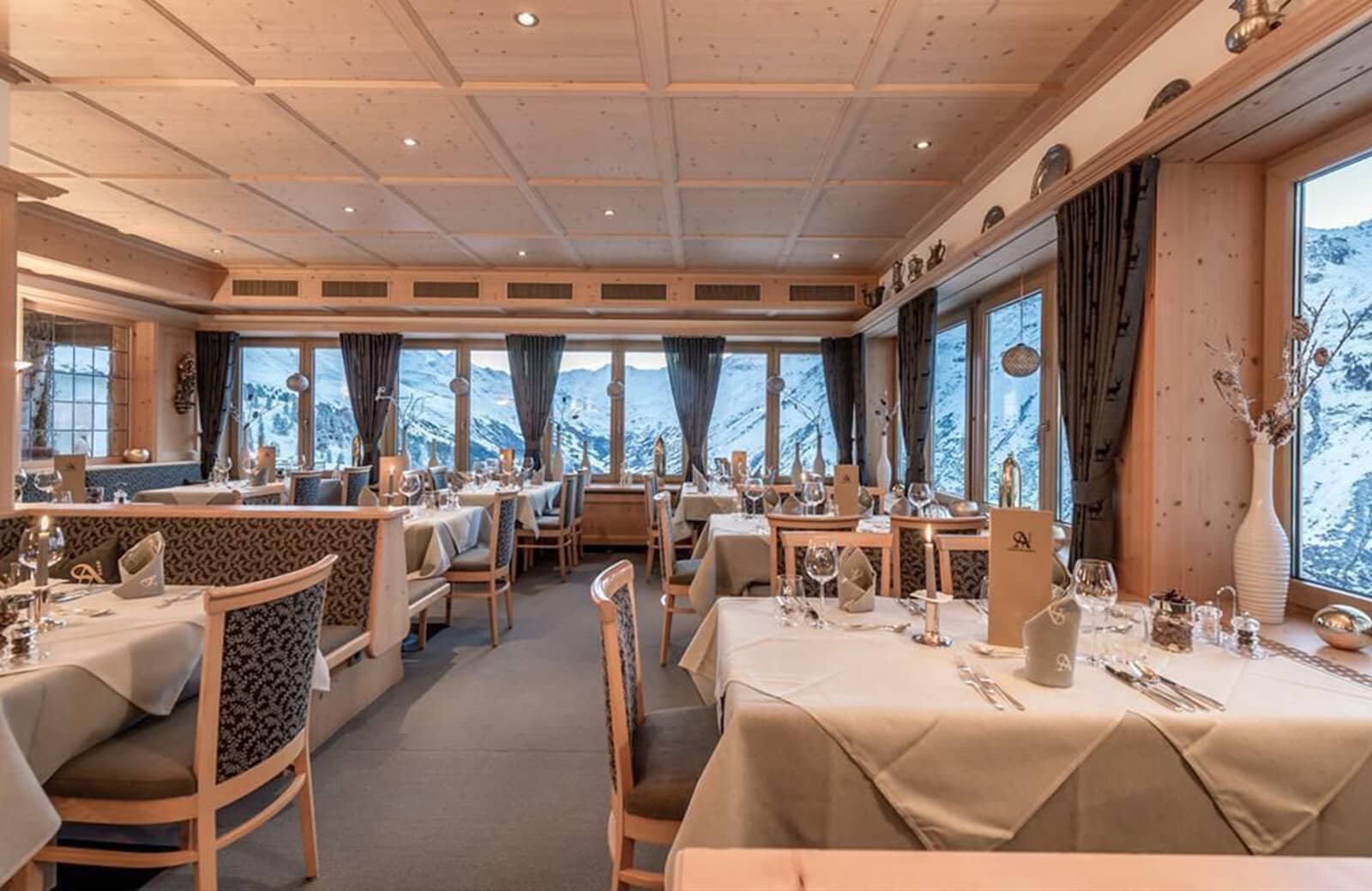 Dining room with coffered wood ceiling and panoramic alpine views