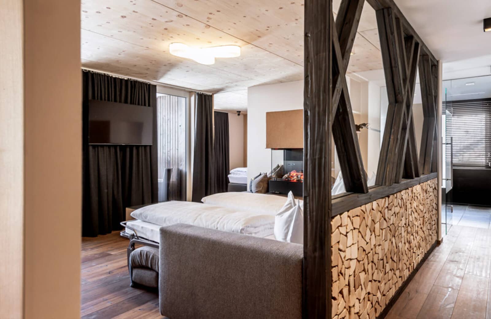 Guest suite with sofa bed, wall-mounted TV, and electric fireplace