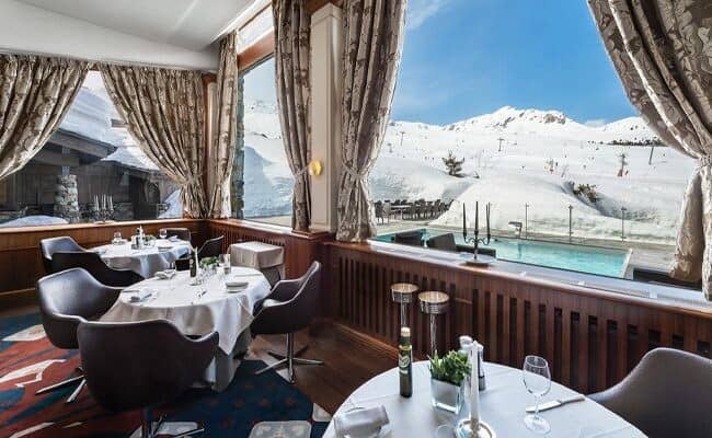 Dining area with ski-in/ski-out views and heated outdoor pool