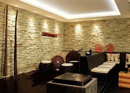 Lounge area with stone accent walls and built-in bench seating